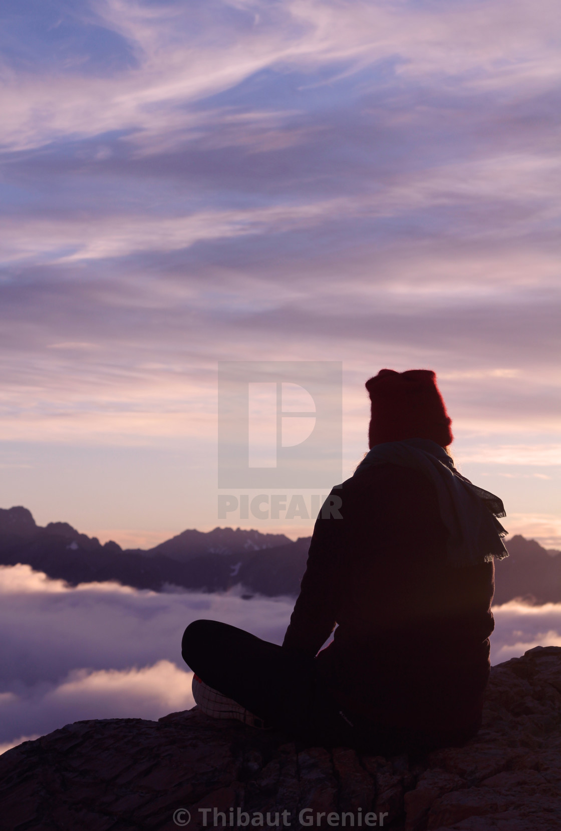 Contemplating an ocean of clouds at dawn